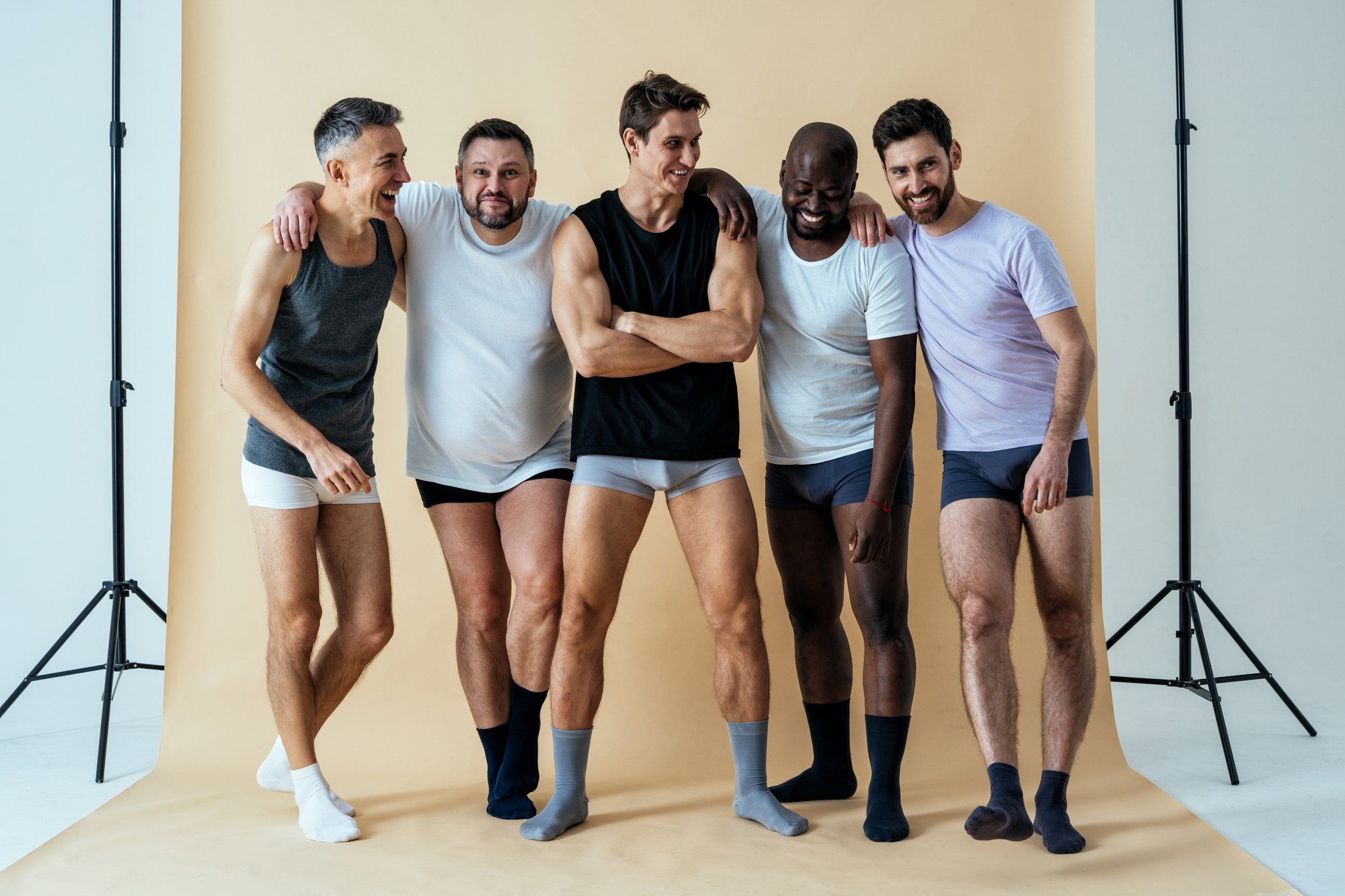 group of multiethnic men posing for a male edition body positive